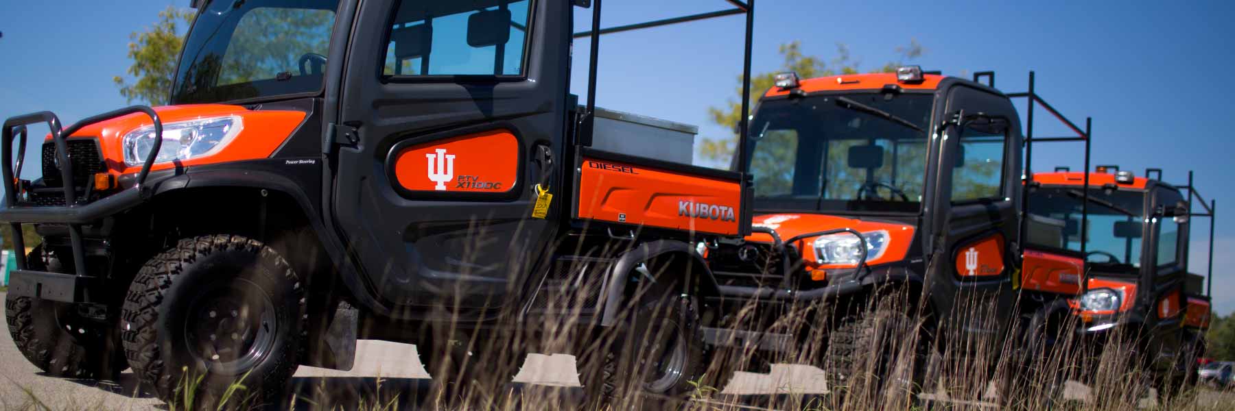 Three parked off-road vehicles.