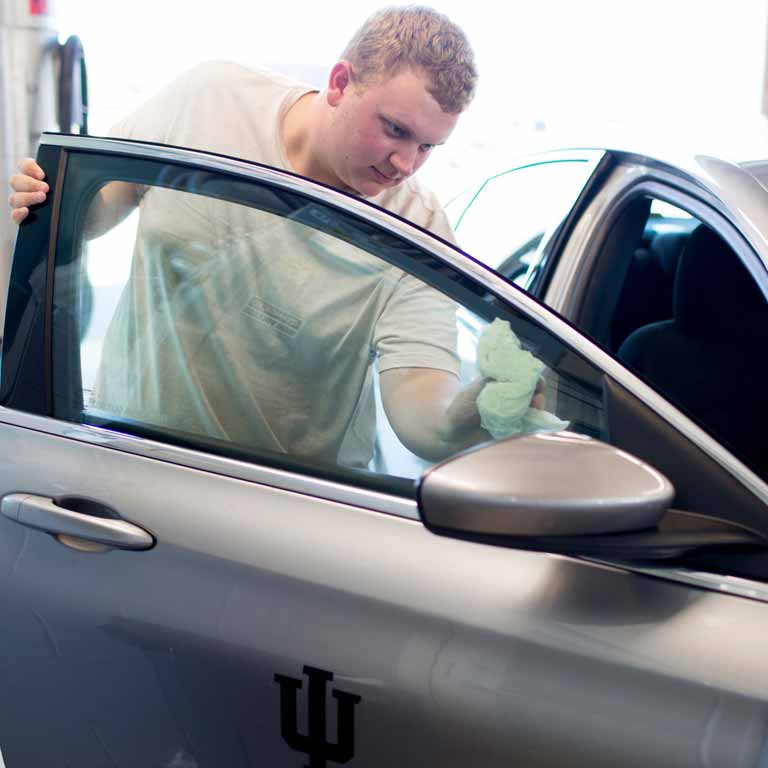 A man washes a vehicle